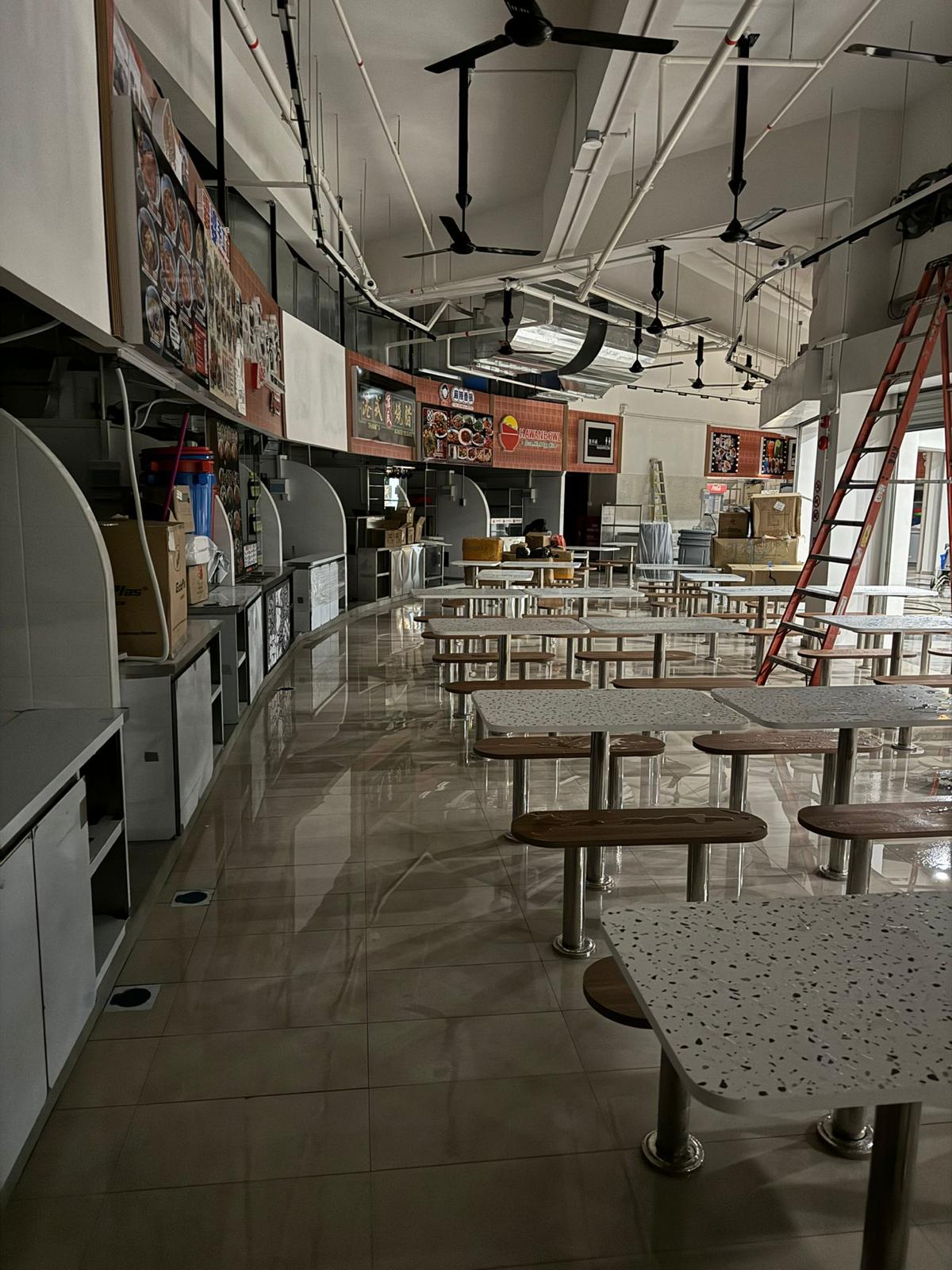 Coffeeshop dining hall with completed stall fronts, signage boards and dining tables